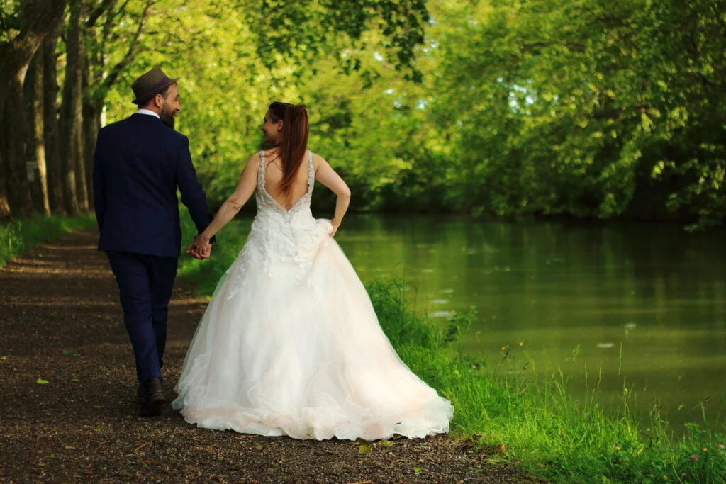 Blog - Les coulisses d'une séance photo au bord du Canal du Midi : Couples de mariés se tenant la main, capturant un moment d'intimité et de complicité le long de ce magnifique lieu emblématique.